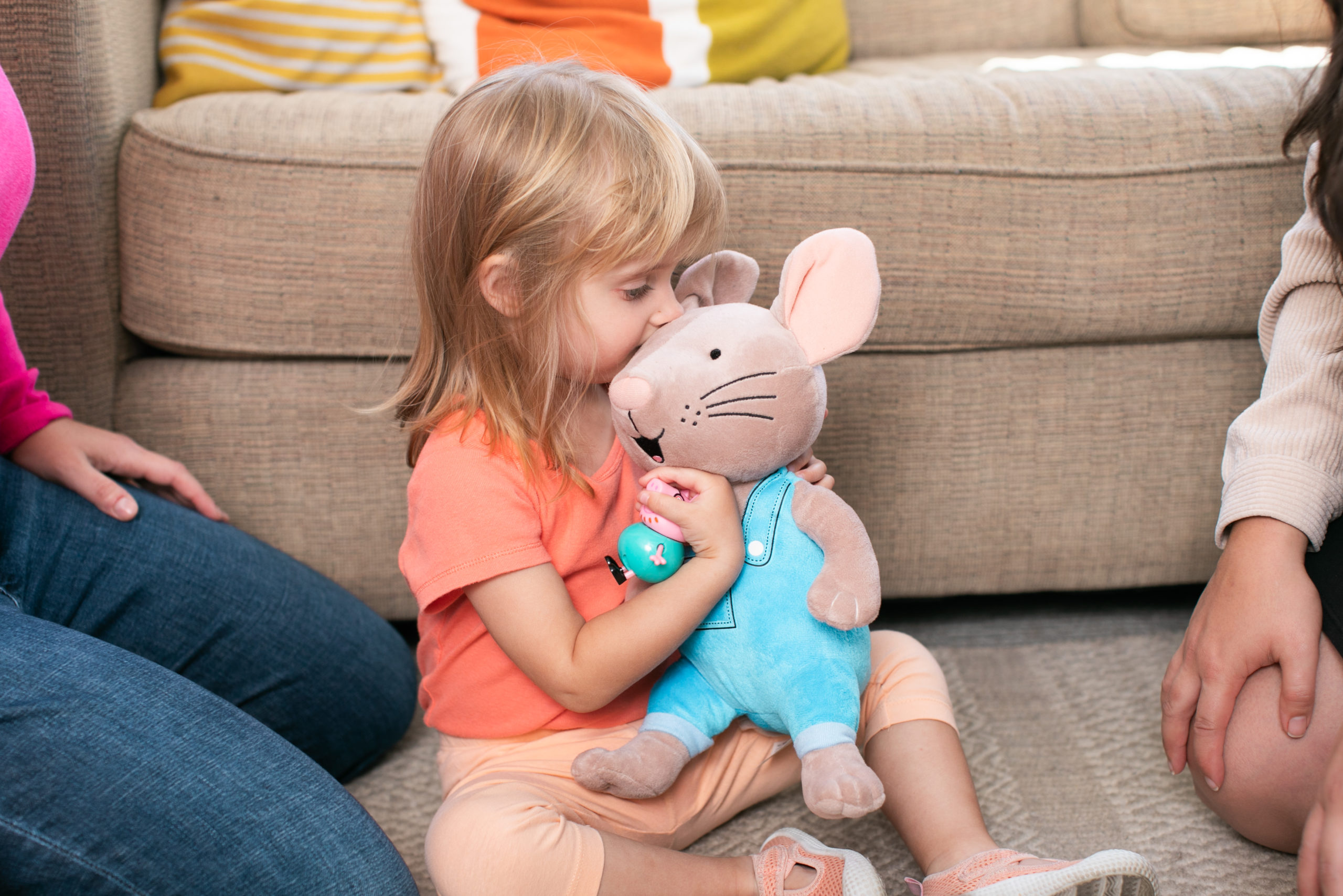 little child holding a stuffed animal mouse